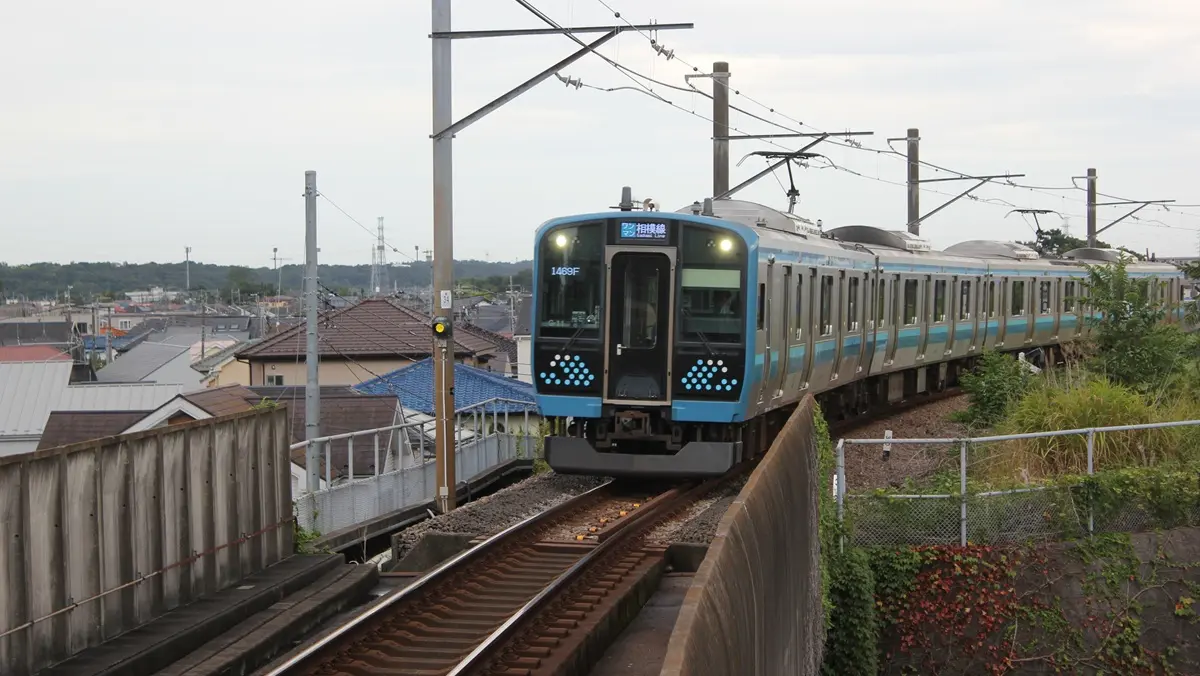 JR Sagami Line E131 series 500 train arriving at Kamimizo Station