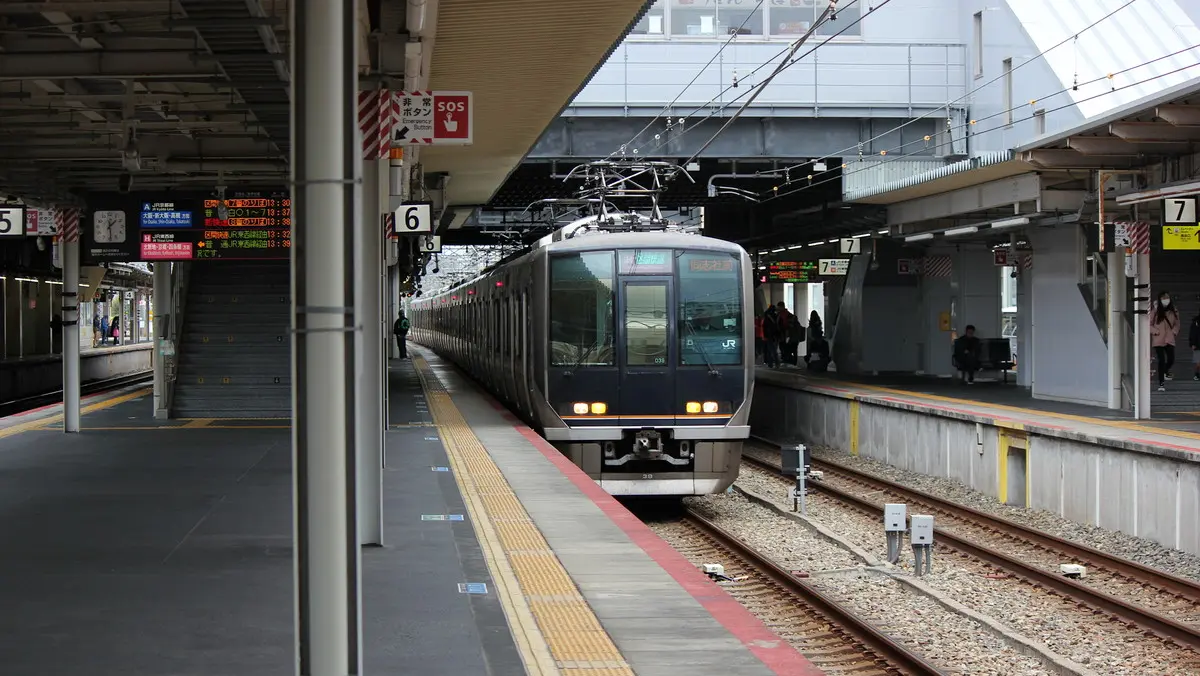 A JR Tozai Line 207 series train stopped at JR Amagasaki Station