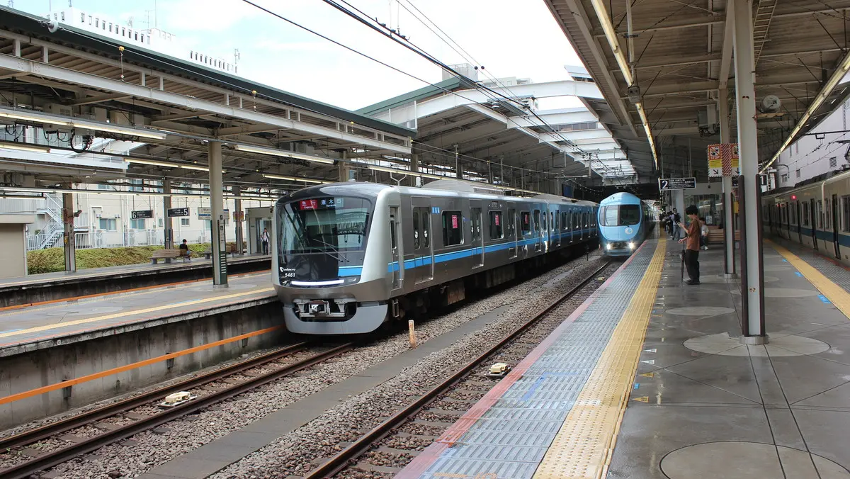 Odakyu Tama Line 5000 series train alongside a Romancecar at Shin-Yurigaoka Station