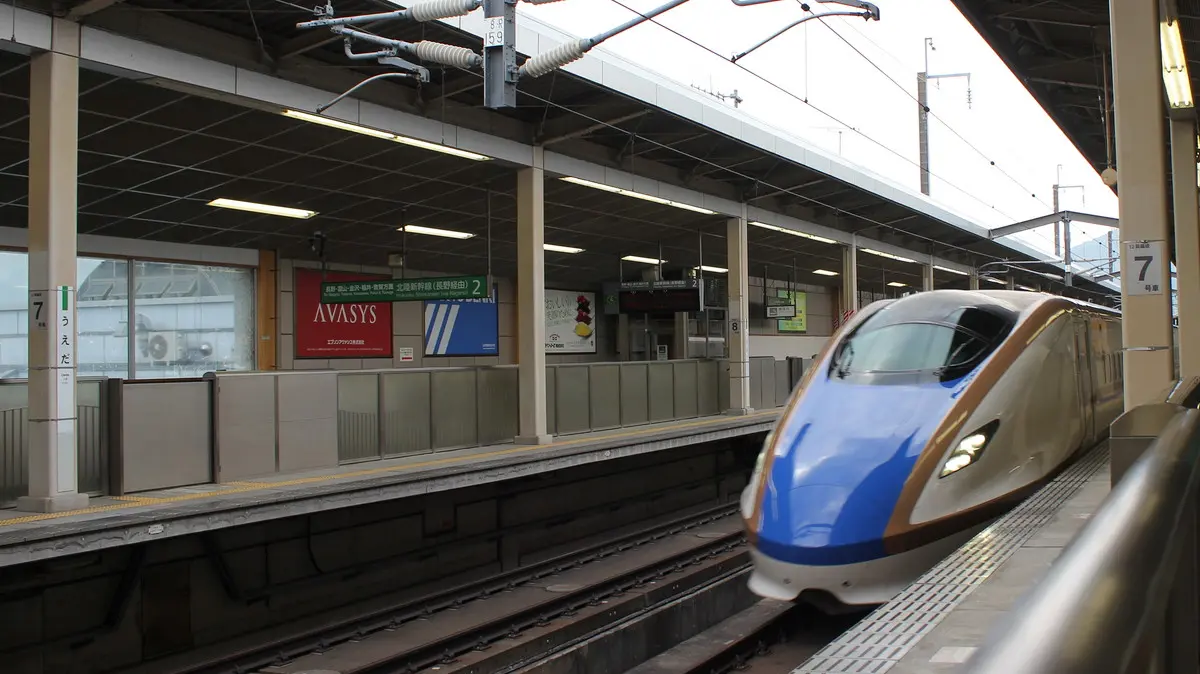 Hokuriku Shinkansen E7 series train departing Ueda Station