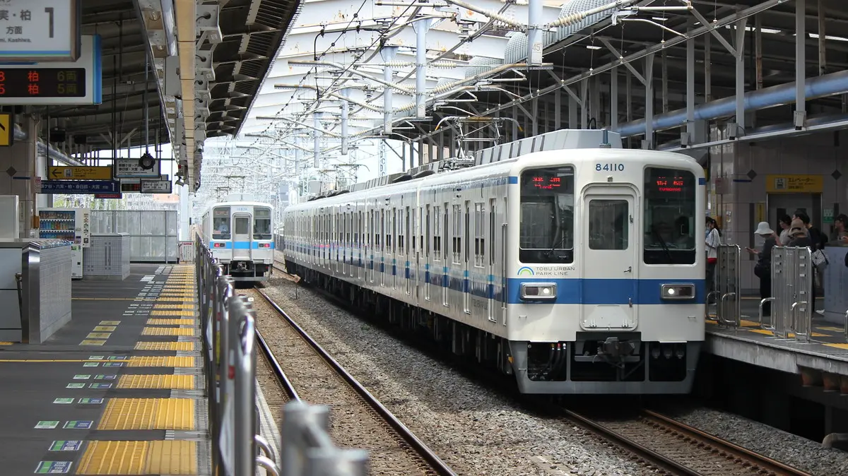 A Tobu 8000 series train, the same model as the Tobu Koizumi Line, is parked at Kamagaya Station