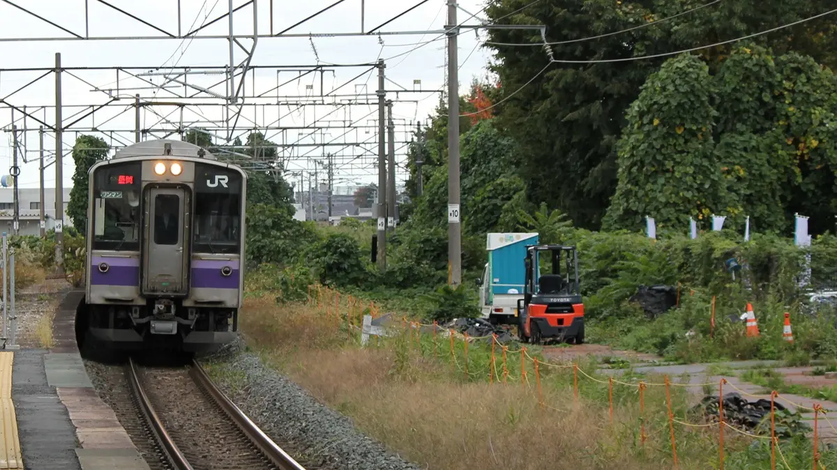 A Tohoku Main Line 701 series train in Morioka colors arriving at Senbokucho Station